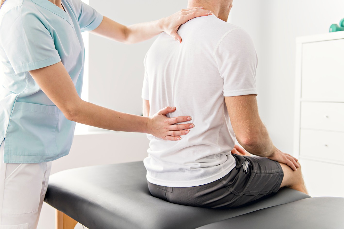 Patient at the physiotherapy doing physical exercises with his therapist